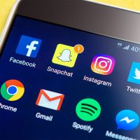 Communicating with Generation Z Mobile phone displaying social network icons